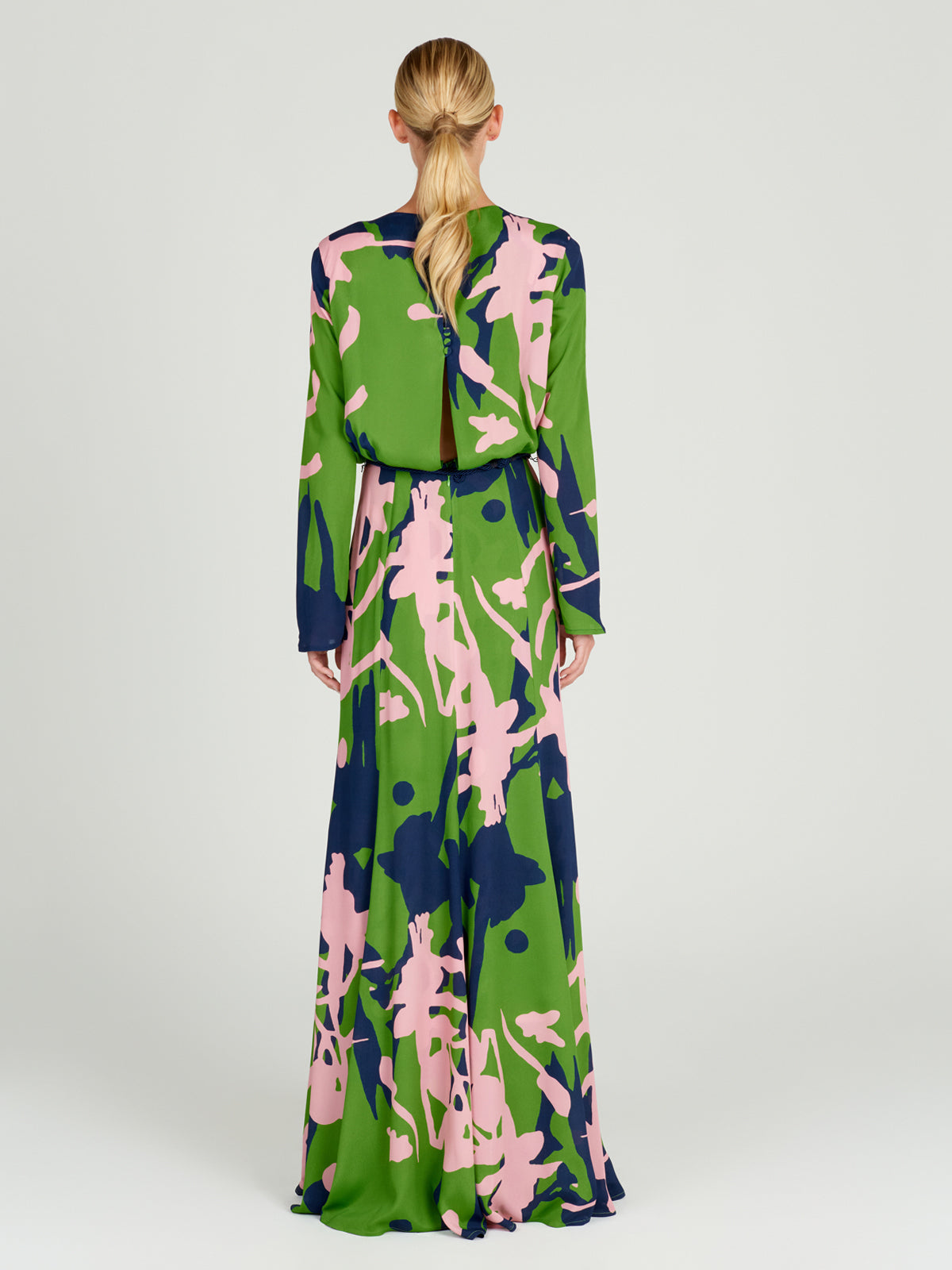 A vibrant printed Ravenna Dress Verdi Pink with a belt.