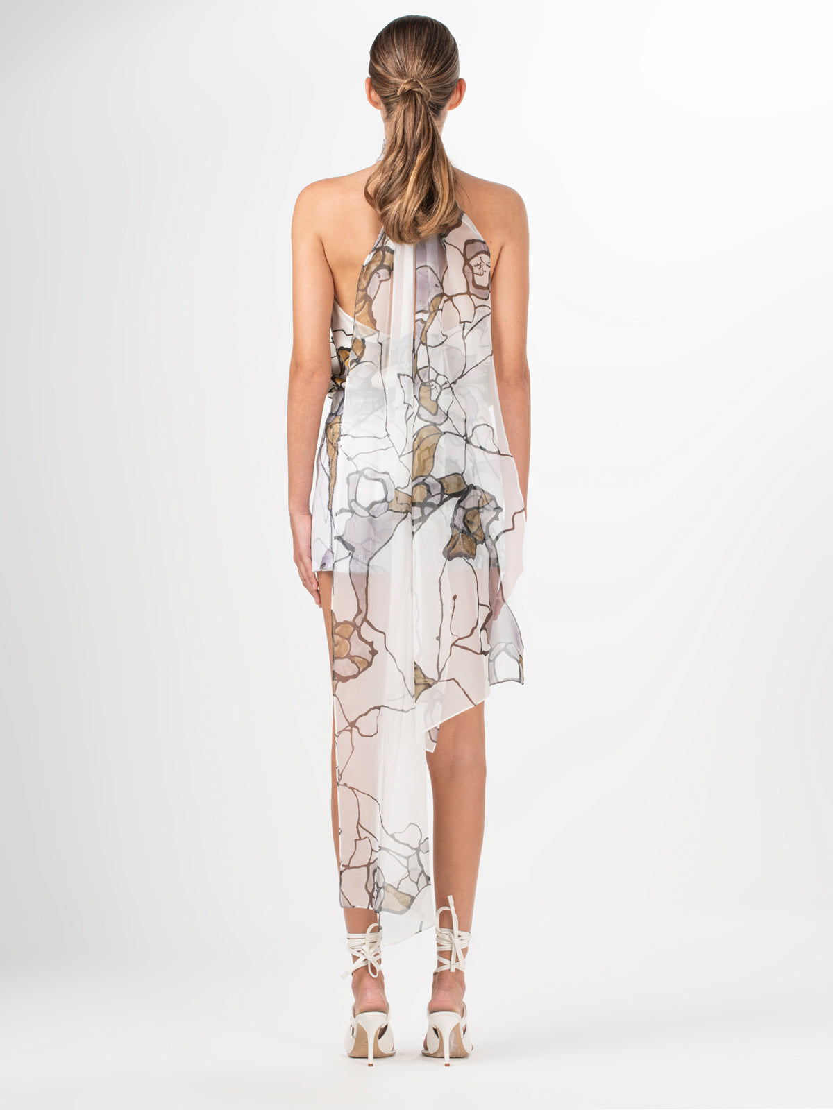 A Geovanna Blouse Ecru Marble with a floral design and sequin detailing.