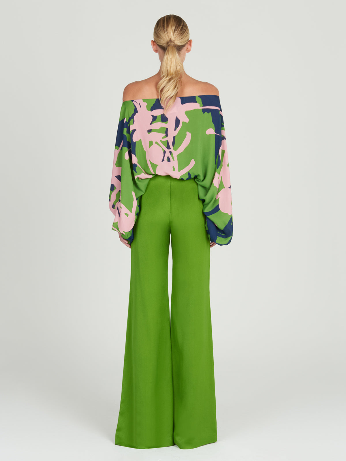 A woman's versatile high-rise Grotte Pant Lime wide leg pants on a white background.