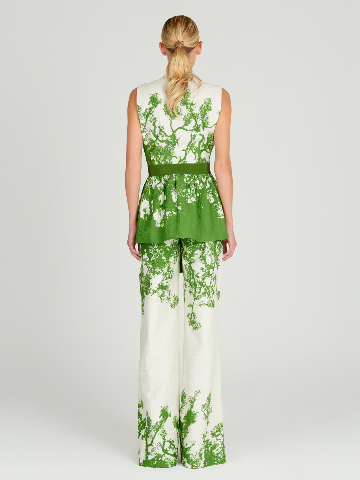 A Colony Blouse Green Cyprus in green and white with a green belt, made of cotton.