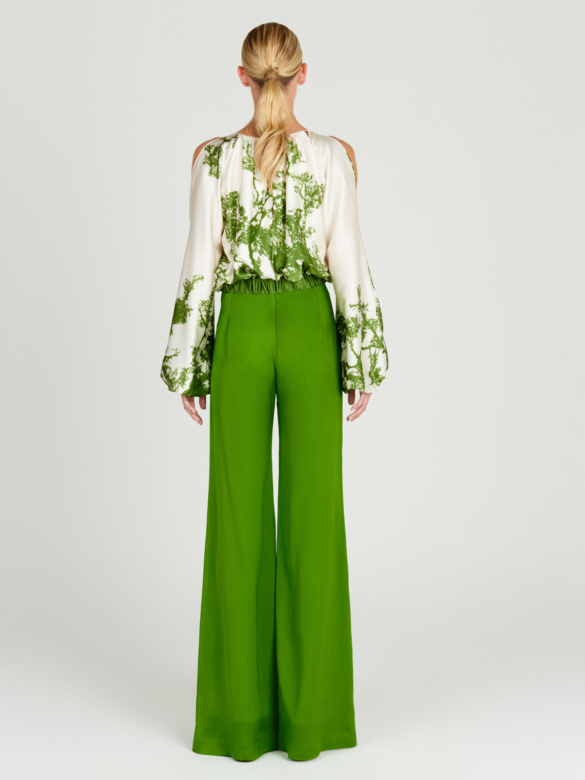 An Elke Blouse Green Cyprus in a nature-inspired print, with an adjustable fit.