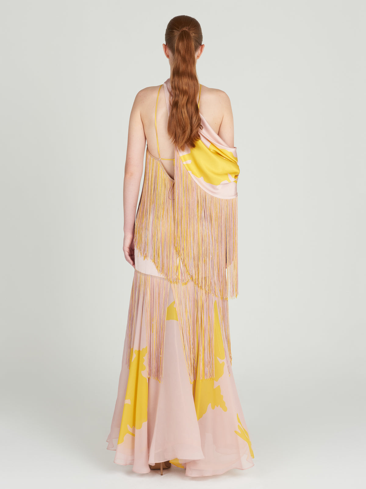 Parma Dress Yellow Nude Floral with fringes and an open back.