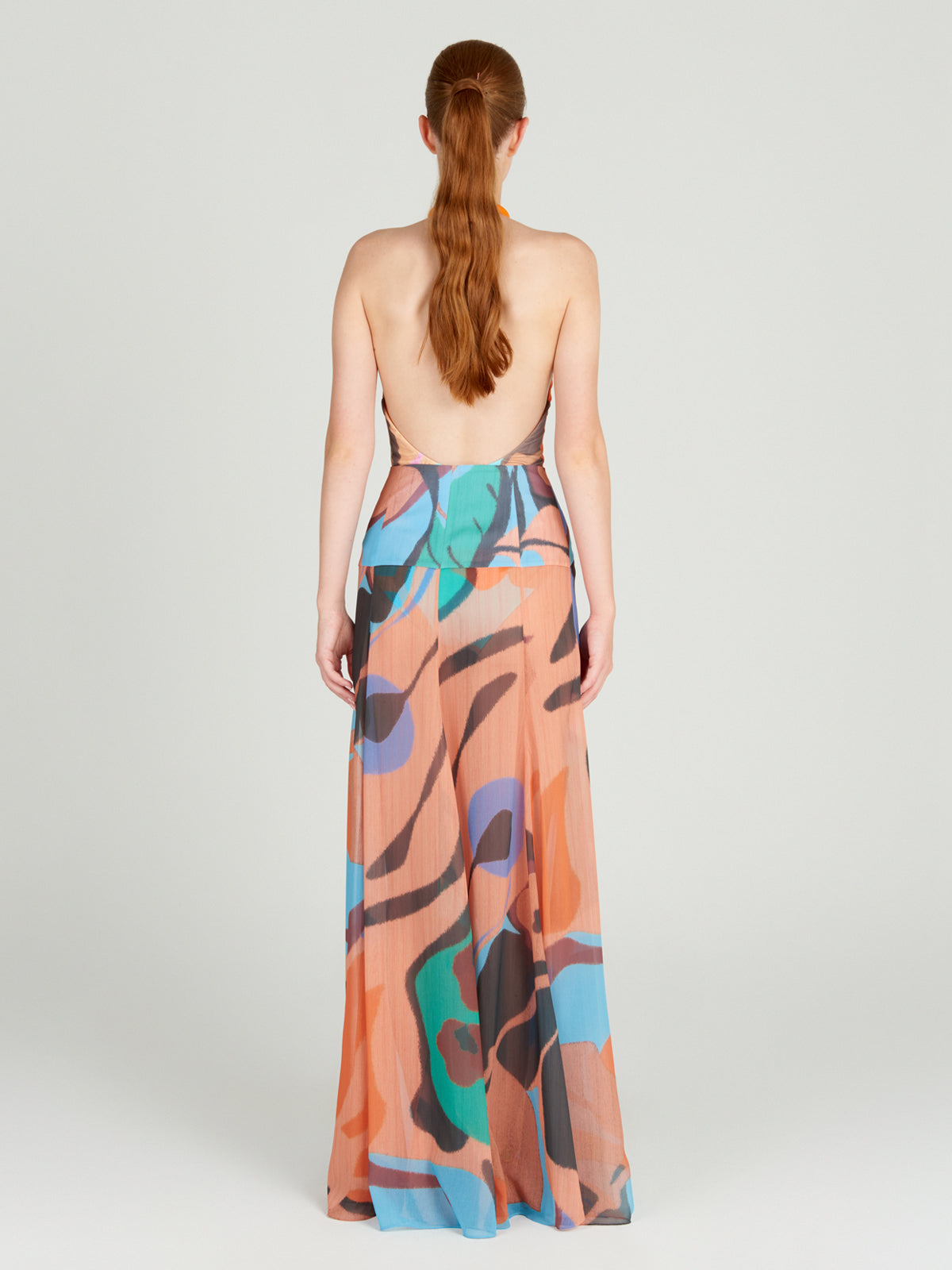 A woman's Cagliari Skirt Pareo Pastel Multi Swirls with a colorful print on it.