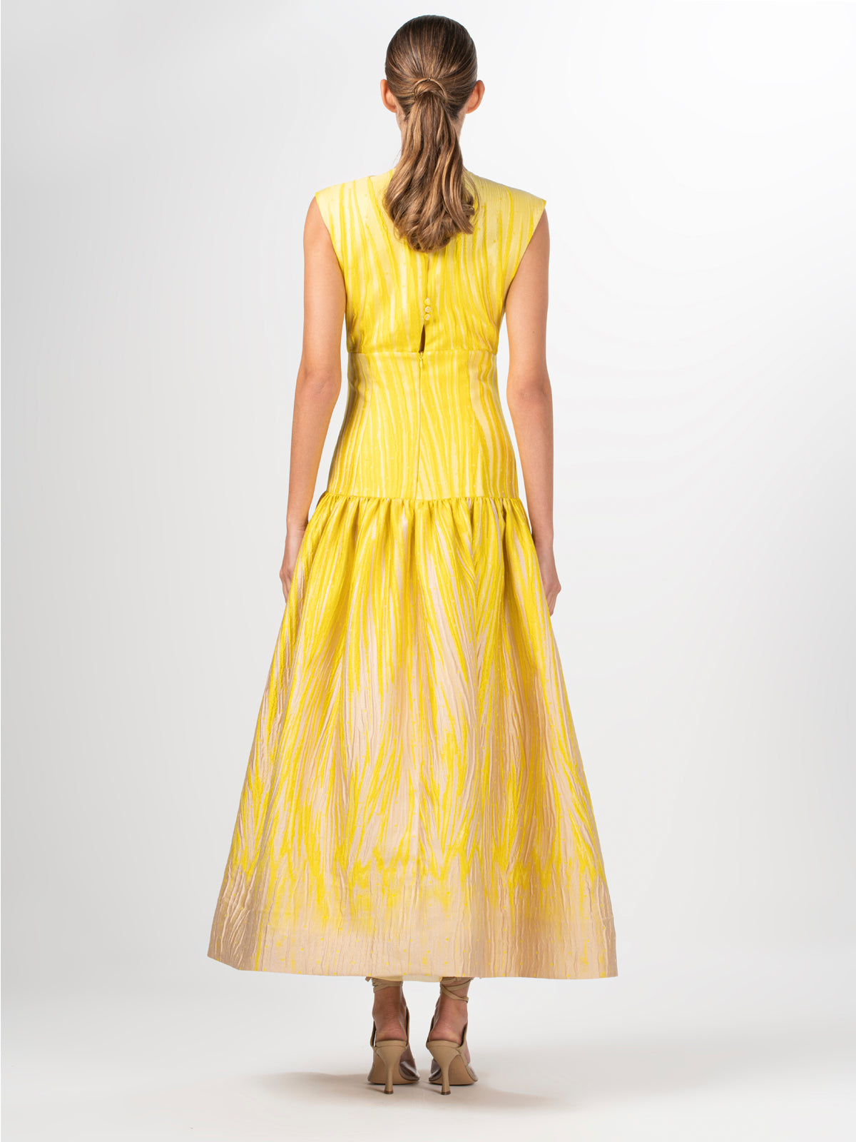 A yellow Leonor Dress Yellow Pink Ripple with guipure lace applique.