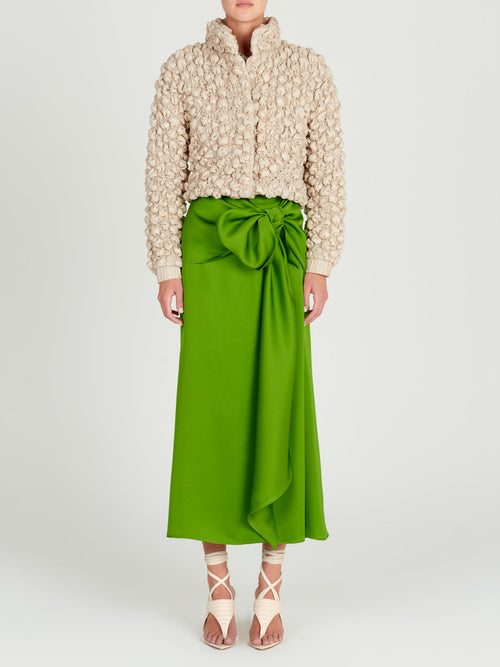 A women's Zalta Jacket Beige with ruffled details.
