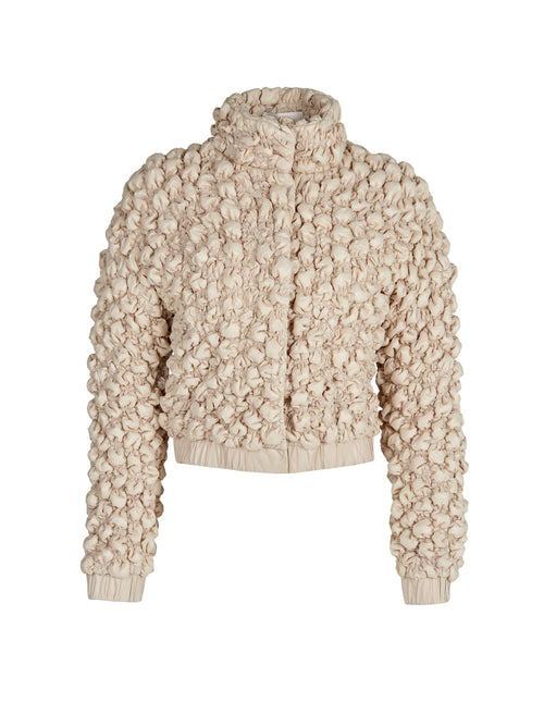 A women's Zalta Jacket Beige with ruffled details.