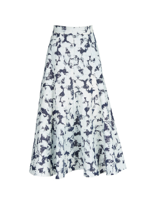 Sentence with product name: A Grettel Skirt White Denim with a black and white print, made of textured denim fabric.
