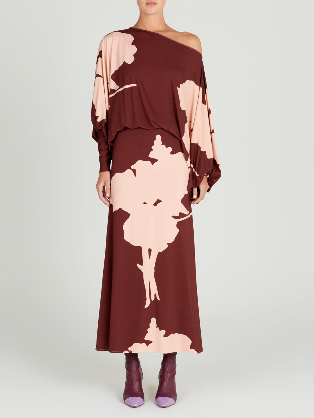 A Calta Dress Cacao Floral with batwing sleeves in a floral print.