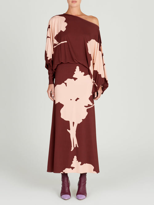 A Calta Dress Cacao Floral with batwing sleeves in a floral print.