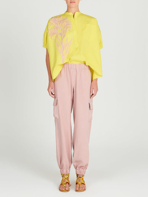 A Susanne Blouse Limoncello with a pink floral design.
