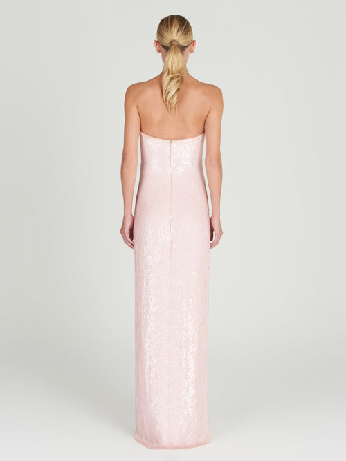 A Margaret Dress Yellow Nude Floral hand-embroidered with a gold flower.