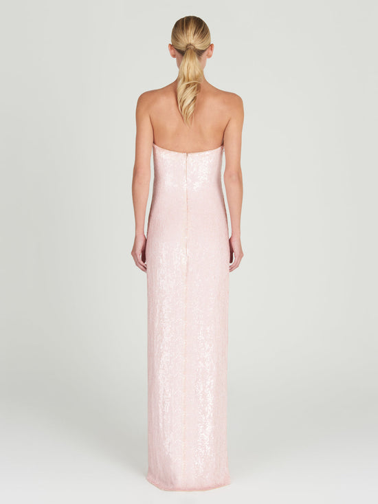 A Margaret Dress Yellow Nude Floral hand-embroidered with a gold flower.