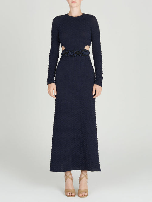 A Myriam Dress Navy with a braided belt.