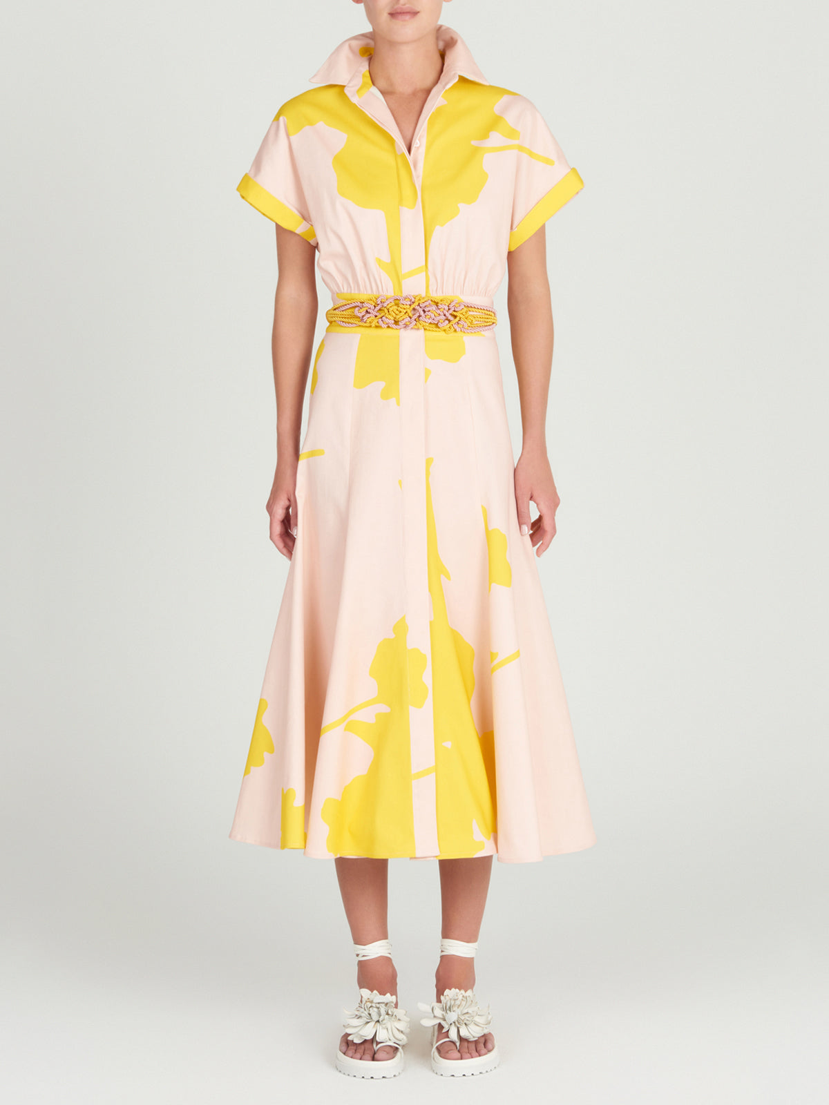 A Noor Dress Yellow Nude Floral with a belt.