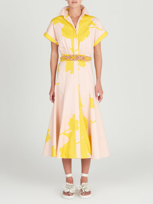 A Noor Dress Yellow Nude Floral with a belt.