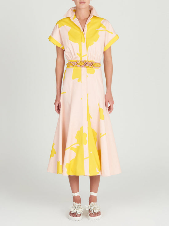 A Noor Dress Yellow Nude Floral with a belt.